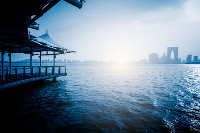 Scenic view of sea by buildings against sky