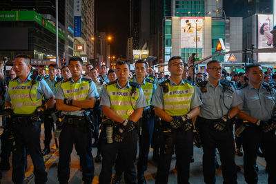 People standing on street at night