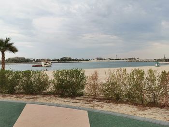 Scenic view of swimming pool by sea against sky