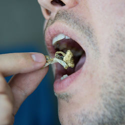 Close-up of man eating food