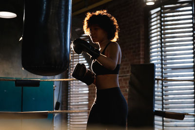 Young woman standing in gym