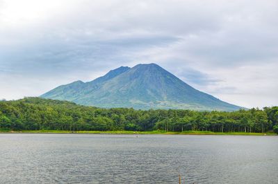 Scenic view of snowcapped mountain against cloudy sky