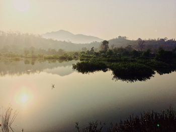 Scenic view of lake against sky during sunset