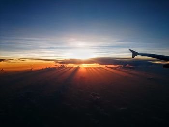 Airplane flying in sky during sunset