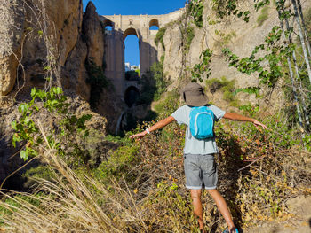 Rear view of man standing on mountain