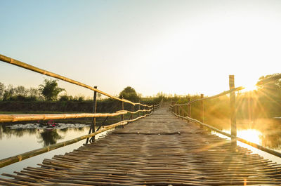 View of bridge over calm sea against clear sky