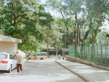 Woman walking on footpath