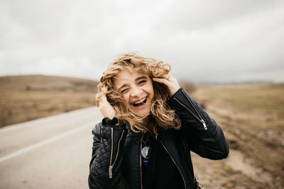 Portrait of woman standing against sky