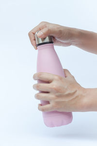 Close-up of woman hand over white background