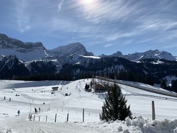 Scenic view of snow covered mountains against sky