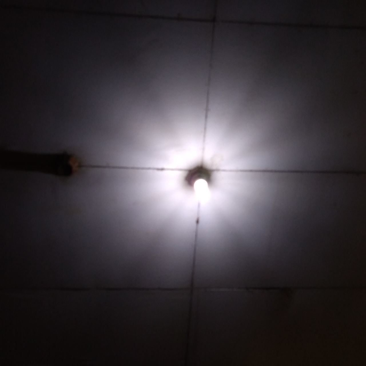 LOW ANGLE VIEW OF ILLUMINATED LIGHT BULBS HANGING ON CEILING