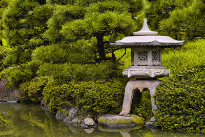 Built structure in garden against trees in park