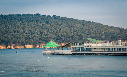 Scenic view of sea and buildings against sky