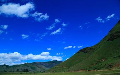 Scenic view of mountains against blue sky