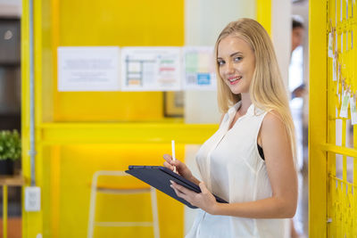 Portrait of young woman using mobile phone