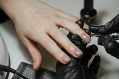 Nail service. cropped view of the girl getting nails done at beauty salon. manicure master doing