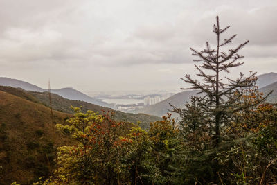Scenic view of mountains against cloudy sky