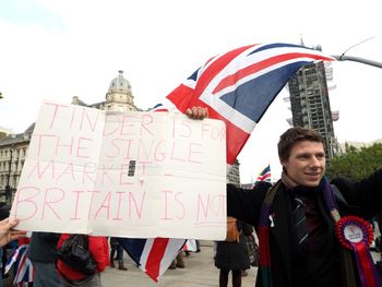 View of man holding flag against sky