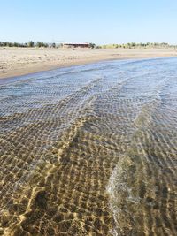 Surface level of sandy beach against sky