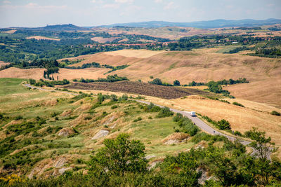 Agricultural panoramic view of asciano area during harvest time, siena province, tuscany, italy