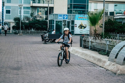 Man riding bicycle on street in city