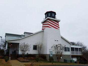 Lifeguard hut in city against sky