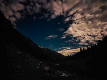 Scenic view of mountains against sky at night