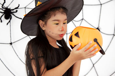 Portrait of girl holding hat