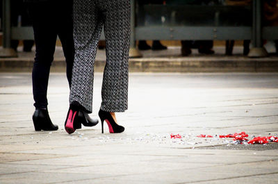 Low section of woman standing on ground