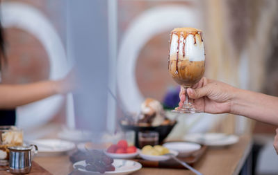 Midsection of woman holding ice cream