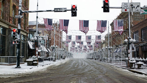 Snow covered road in city