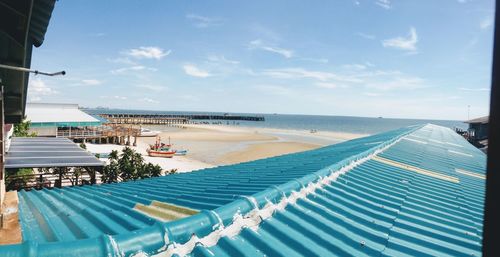 Scenic view of swimming pool by sea against sky