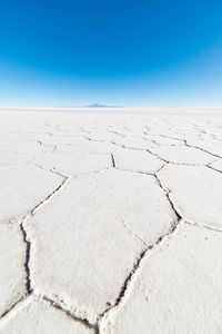 Scenic view of desert against blue sky