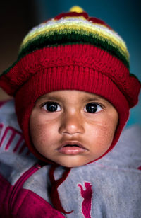 Close-up portrait of cute baby boy wearing warm clothing