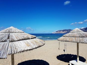 Scenic view of beach against blue sky