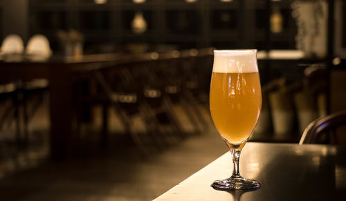 Close-up of beer glass on table
