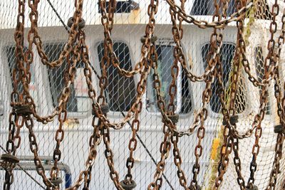 Close-up of fishing net hanging on rope