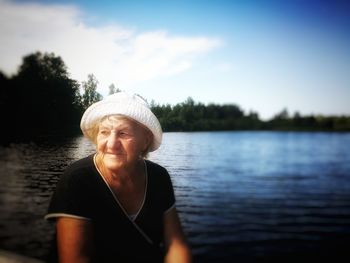 Portrait of woman in lake against sky