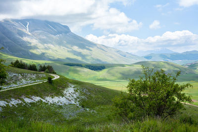 Scenic view of mountains against cloudy sky