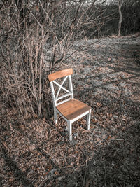 High angle view of empty chair on field