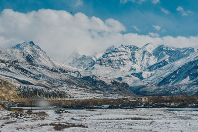 Scenic view of snowcapped mountains against sky