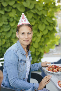 Young woman in party hat at crayfish party