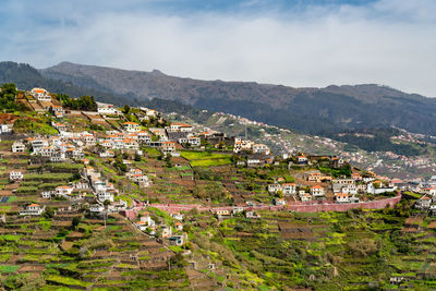 Town by mountain against sky