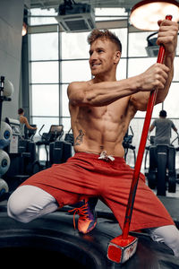 Low section of man exercising in gym