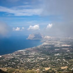 Scenic view of sea and mountains against sky