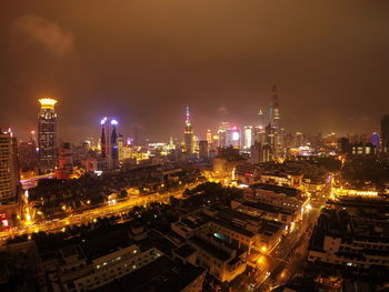 Aerial view of city lit up at night