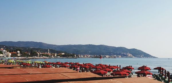 Boats in sea against clear sky