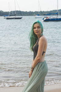 Young woman standing on sea shore