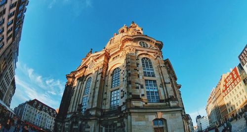 Low angle view of buildings against blue sky