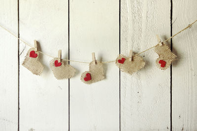 Close-up of christmas decoration hanging against white wall